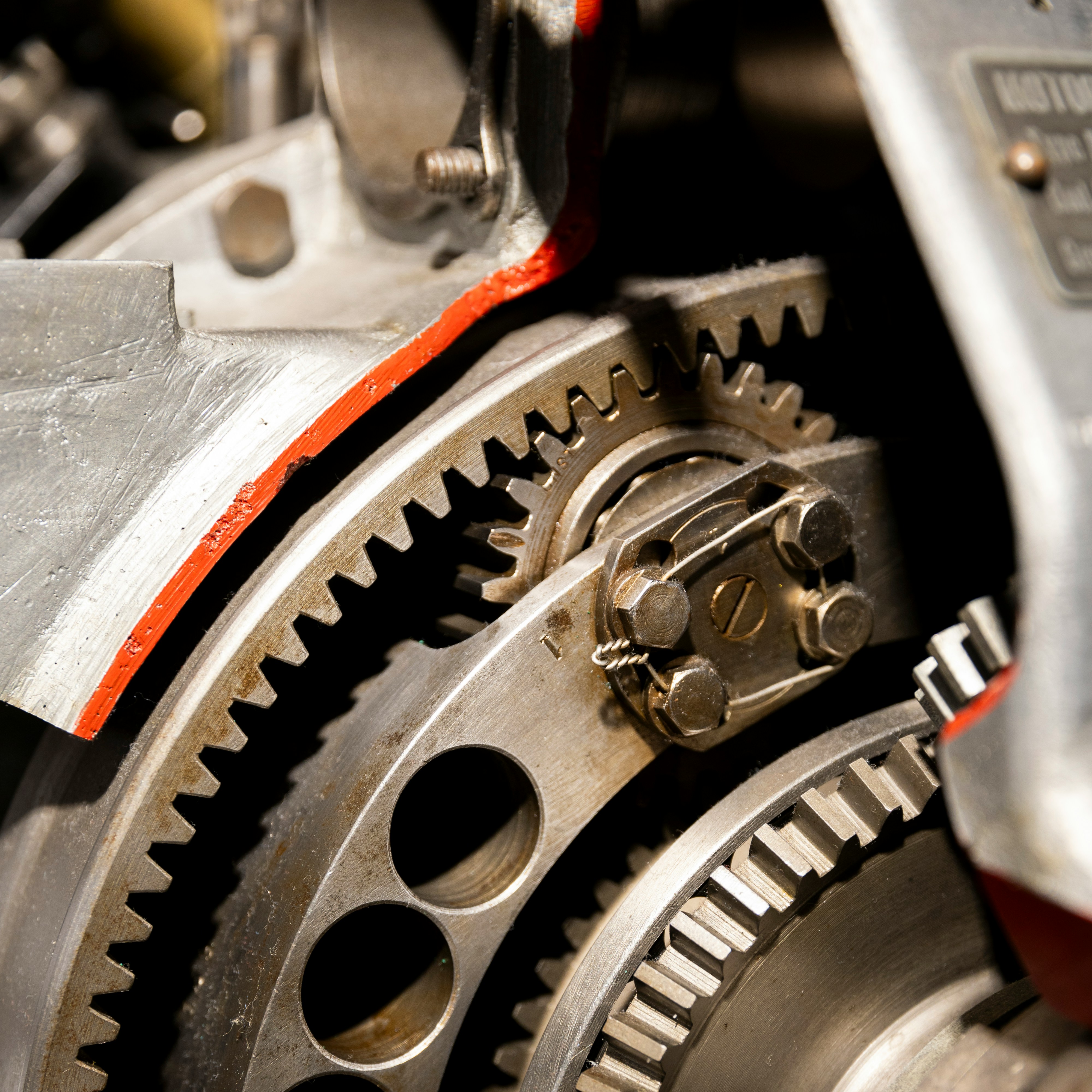 Close-up of transmission gear components with red accents