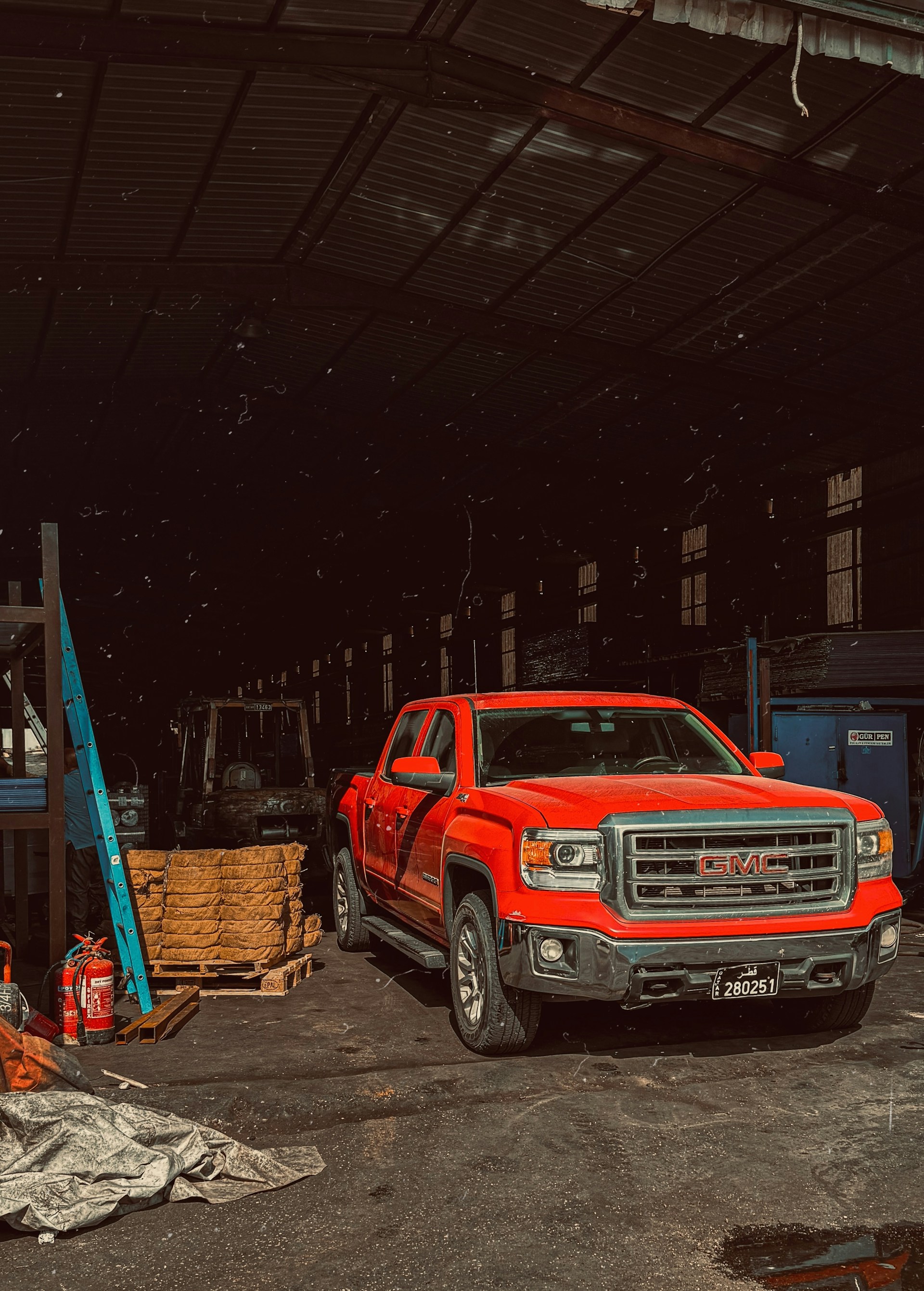 Red truck being serviced inside the Shalimar Transmission garage